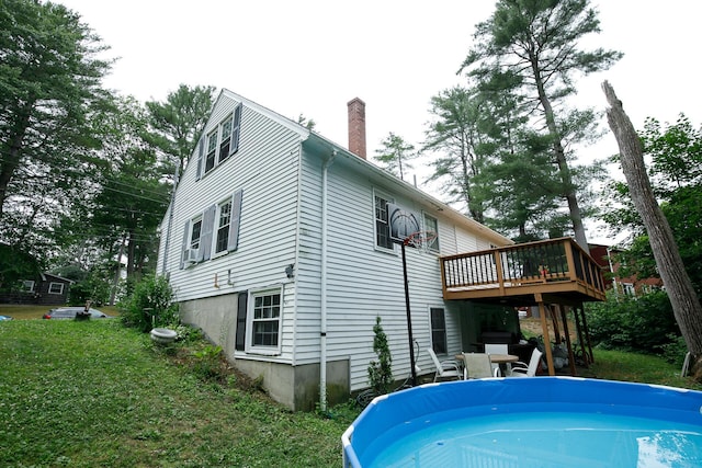 17 Duncan Rd, Augusta, ME 04330 - back of house featuring a deck, a chimney, an outdoor pool, and a lawn