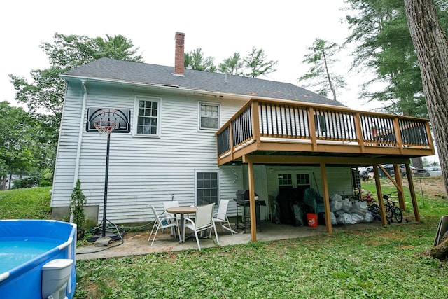 17 Duncan Rd, Augusta, ME 04330 - back of house featuring a wooden deck, a chimney, a patio, a yard, and a shingled roof