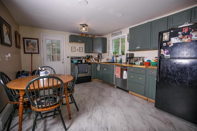 17 Duncan Rd, Augusta, ME 04330 - kitchen with freestanding refrigerator, stove, stainless steel dishwasher, and a baseboard radiator