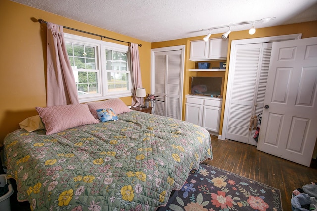 17 Duncan Rd, Augusta, ME 04330 - bedroom featuring multiple closets, wood-type flooring, track lighting, and a textured ceiling