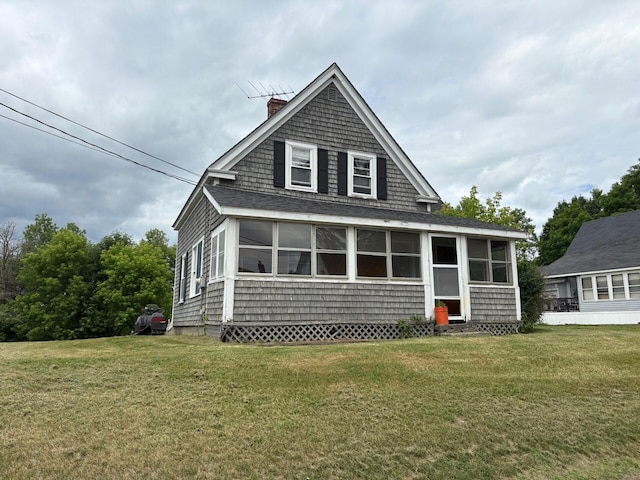 41 S Main St, Burnham, ME 04922 - view of front facade featuring a chimney, a front yard, and a sunroom