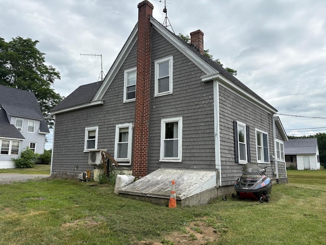 41 S Main St, Burnham, ME 04922 - back of house featuring a chimney and a lawn