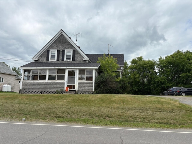 41 S Main St, Burnham, ME 04922 - bungalow-style house with roof with shingles, a sunroom, and a front yard