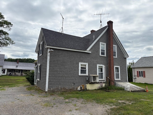 41 S Main St, Burnham, ME 04922 - rear view of house featuring roof with shingles and a chimney