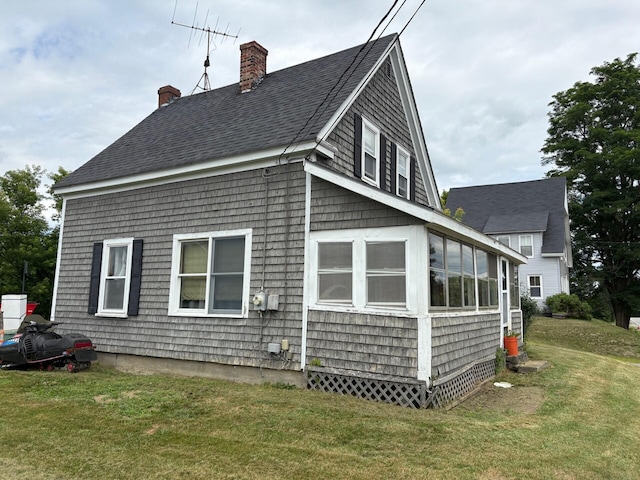 41 S Main St, Burnham, ME 04922 - view of side of home with a chimney, a yard, and a shingled roof