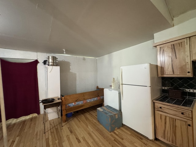 1698 Exeter Rd, Exeter, ME 04435 - kitchen featuring freestanding refrigerator, tile counters, light wood-style floors, backsplash, and washer / clothes dryer