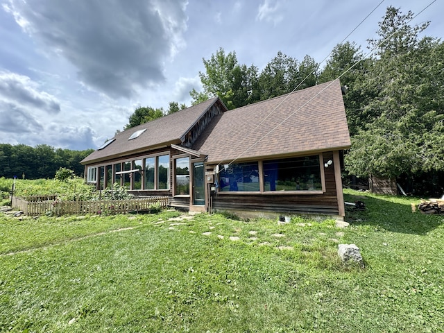 1698 Exeter Rd, Exeter, ME 04435 - rustic home featuring a sunroom, a front lawn, and a shingled roof