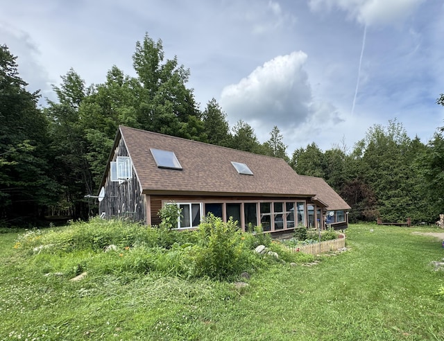 1698 Exeter Rd, Exeter, ME 04435 - back of house with a shingled roof, a yard, a sunroom, and a forest view