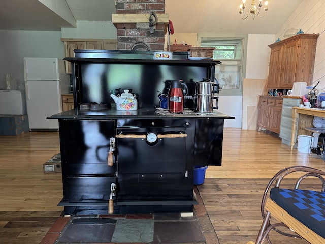 1698 Exeter Rd, Exeter, ME 04435 - kitchen featuring freestanding refrigerator, wood finished floors, a chandelier, and lofted ceiling