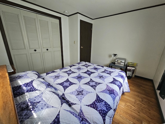 381 Birch St, Bangor, ME 04401 - bedroom with wood finished floors, a closet, and ornamental molding