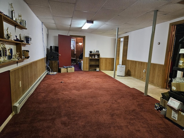 381 Birch St, Bangor, ME 04401 - finished basement with a wainscoted wall, baseboard heating, wooden walls, a drop ceiling, and carpet floors
