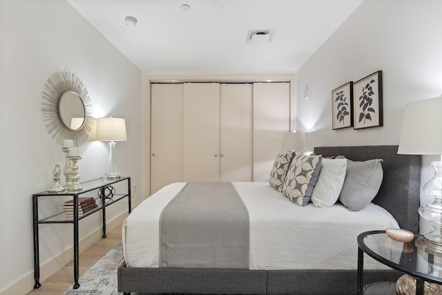 166 Fore St Unit 25, Portland, ME 04101 - bedroom featuring light wood-style floors and a closet