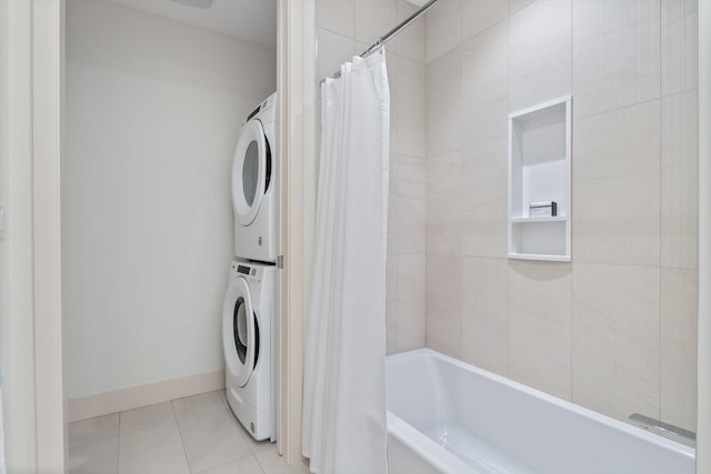 166 Fore St Unit 25, Portland, ME 04101 - full bath featuring estacked washer and dryer, shower / bathtub combination with curtain, and tile patterned flooring