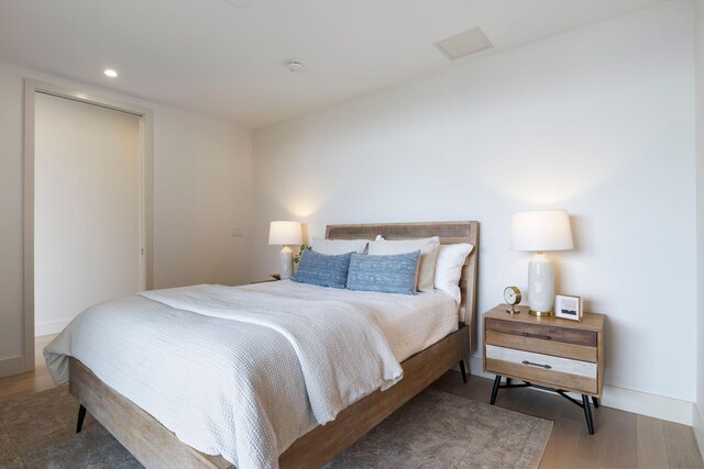 166 Fore St Unit 25, Portland, ME 04101 - bedroom featuring wood finished floors and recessed lighting