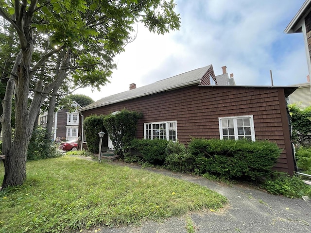 30 Dow St, Portland, ME 04102 - view of side of home featuring a chimney and a lawn