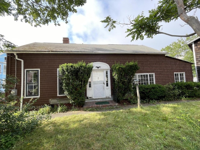 30 Dow St, Portland, ME 04102 - view of front of property with a chimney, a front lawn, and roof with shingles