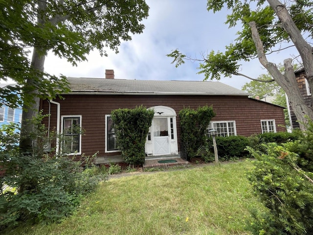 30 Dow St, Portland, ME 04102 - view of front facade with a chimney and a front yard