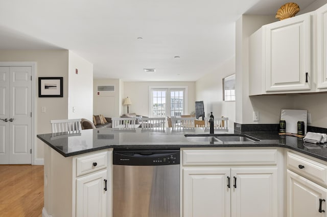 1 E Grand Ave Unit 503, Old Orchard Beach, ME 04064 - kitchen with dishwasher, dark stone counters, white cabinets, open floor plan, and light wood-style flooring