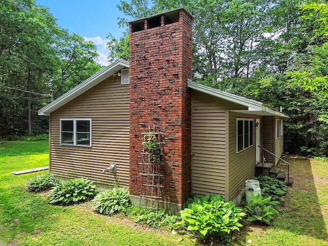 2672 N Belfast Ave, Augusta, ME 04330 - view of side of property with a chimney, a yard, and entry steps