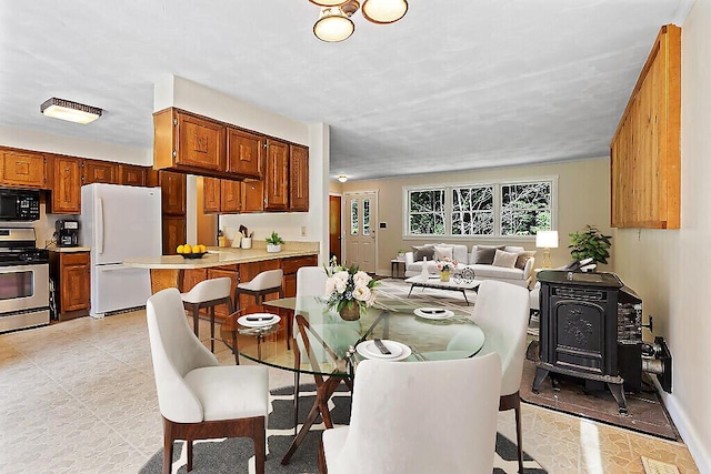 2672 N Belfast Ave, Augusta, ME 04330 - dining room featuring a wood stove