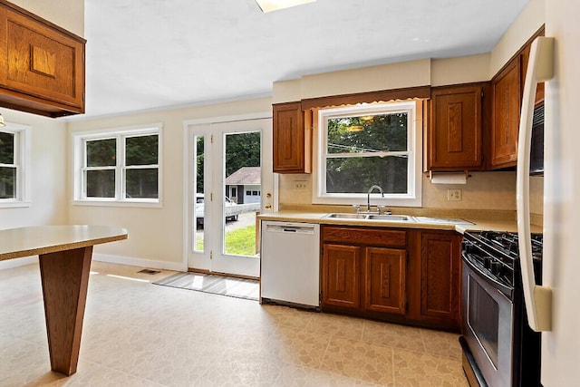 2672 N Belfast Ave, Augusta, ME 04330 - kitchen featuring dishwasher, stainless steel range with gas cooktop, light countertops, and brown cabinets