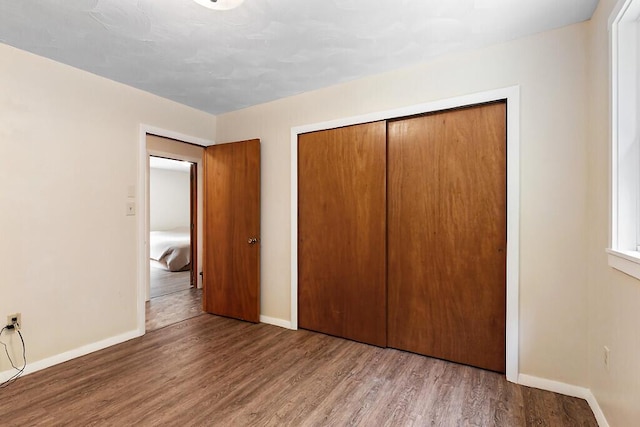 2672 N Belfast Ave, Augusta, ME 04330 - unfurnished bedroom featuring wood finished floors and a closet