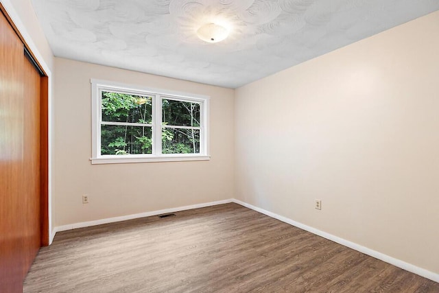 2672 N Belfast Ave, Augusta, ME 04330 - unfurnished bedroom with wood finished floors and a closet