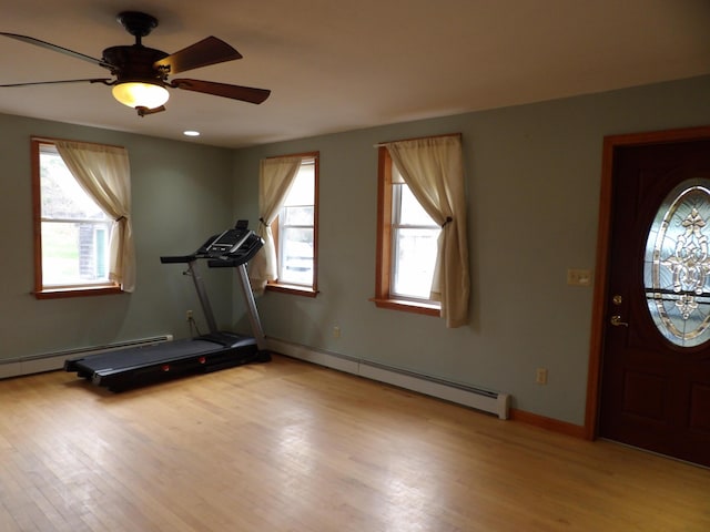 953 Pushaw Rd, Glenburn, ME 04401 - workout area featuring light wood-style floors, a baseboard radiator, and a ceiling fan