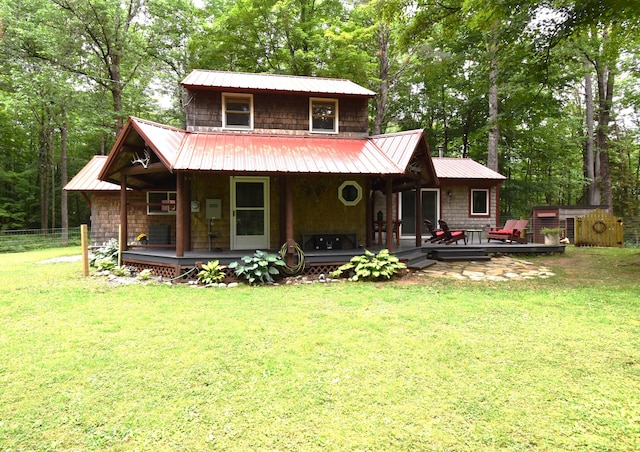108 Maple Rd, Atkinson, ME 04426 - view of front facade with a porch, view of wooded area, and a metal roof