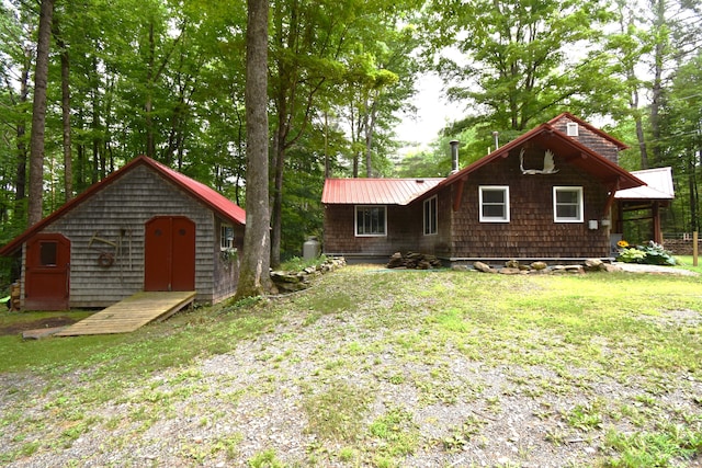 108 Maple Rd, Atkinson, ME 04426 - back of property with a storage unit, a yard, and a metal roof
