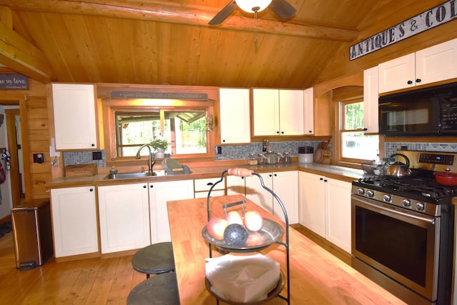 108 Maple Rd, Atkinson, ME 04426 - kitchen with stainless steel gas range oven, black microwave, wood ceiling, decorative backsplash, and white cabinets