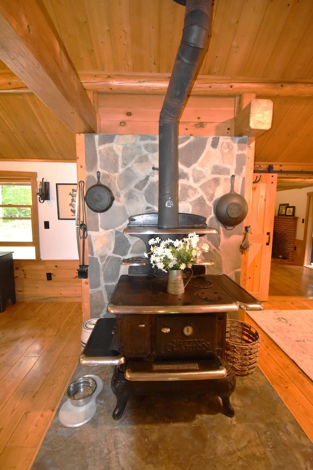 108 Maple Rd, Atkinson, ME 04426 - detailed view of a wood ceiling with exposed beams, wood finished floors, a wood stove, and wooden walls