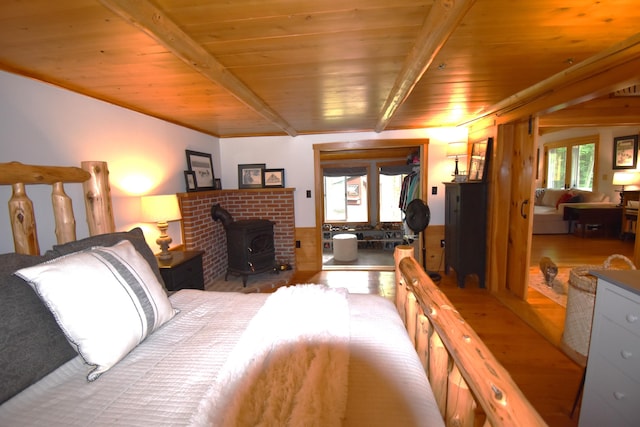 108 Maple Rd, Atkinson, ME 04426 - bedroom with a wood ceiling with exposed beams and a wood stove