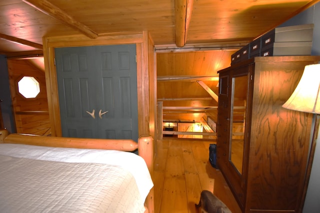 108 Maple Rd, Atkinson, ME 04426 - bedroom with a wooden ceiling with exposed beams, hardwood / wood-style flooring, and wood walls