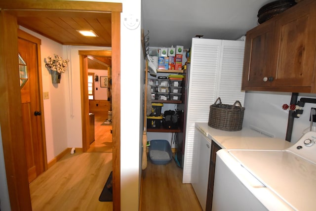 108 Maple Rd, Atkinson, ME 04426 - laundry area featuring cabinet space, light wood-type flooring, and washing machine and clothes dryer