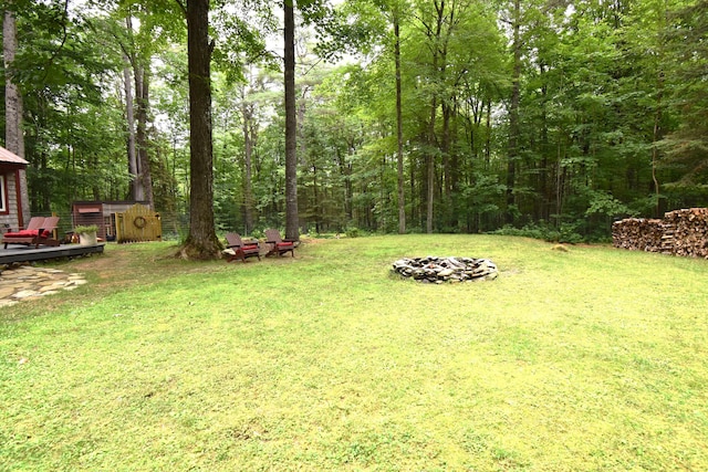 108 Maple Rd, Atkinson, ME 04426 - view of grassy yard featuring a fire pit and a deck
