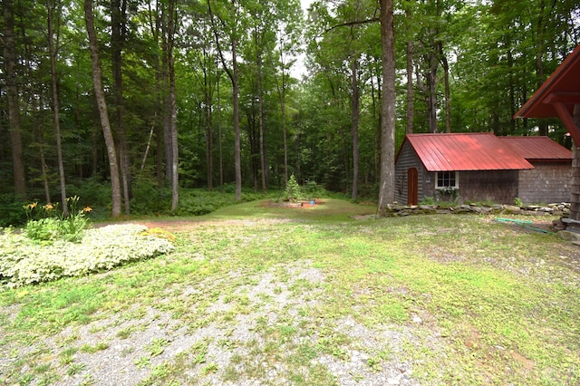 108 Maple Rd, Atkinson, ME 04426 - view of green lawn with an outdoor structure and a forest view