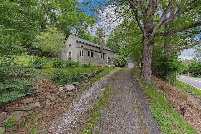 131 River Rd, Newcastle, ME 04553 - view of front facade with an outbuilding, driveway, and a garage