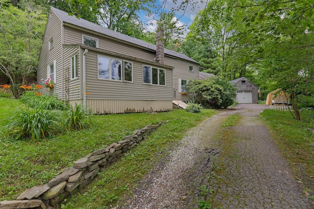 131 River Rd, Newcastle, ME 04553 - view of front of house featuring an outdoor structure, driveway, and a detached garage