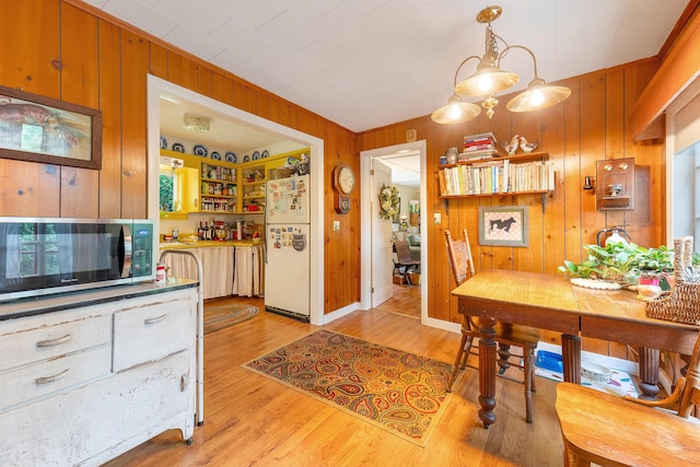 131 River Rd, Newcastle, ME 04553 - dining room with wood walls and light wood-type flooring