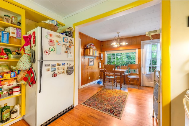 131 River Rd, Newcastle, ME 04553 - kitchen featuring freestanding refrigerator, light wood-style flooring, a chandelier, wooden walls, and open shelves
