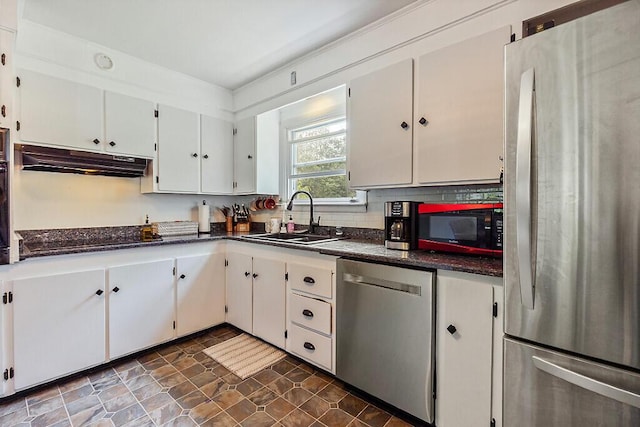 77 W River Rd, Waterville, ME 04901 - kitchen with stainless steel appliances, under cabinet range hood, white cabinets, and decorative backsplash