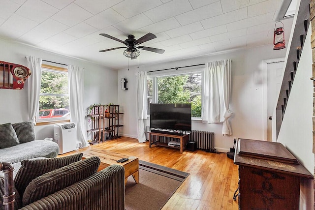 77 W River Rd, Waterville, ME 04901 - living area with radiator, a ceiling fan, light wood finished floors, and stairs