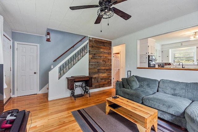 77 W River Rd, Waterville, ME 04901 - living room with stairway, light wood-type flooring, ceiling fan, and wood walls