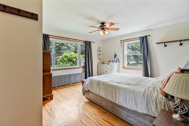 77 W River Rd, Waterville, ME 04901 - bedroom with radiator heating unit, hardwood / wood-style floors, ceiling fan, and cooling unit