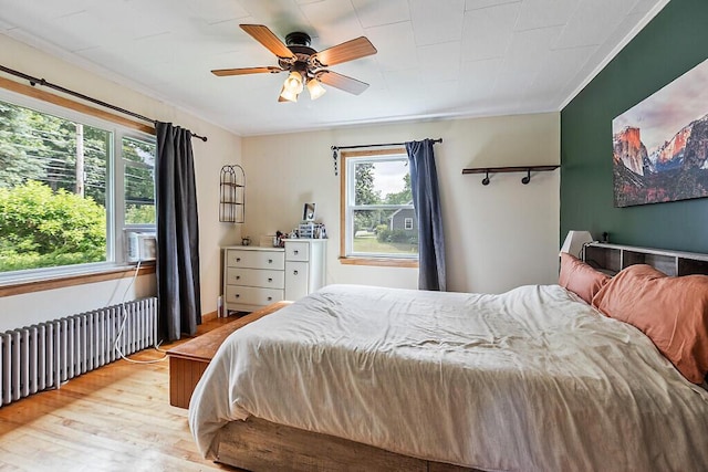 77 W River Rd, Waterville, ME 04901 - bedroom featuring radiator heating unit, light wood-type flooring, ornamental molding, cooling unit, and ceiling fan