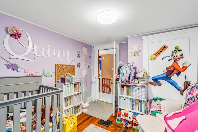 131 Pleasant St, Dexter, ME 04930 - bedroom with wood finished floors and a nursery area
