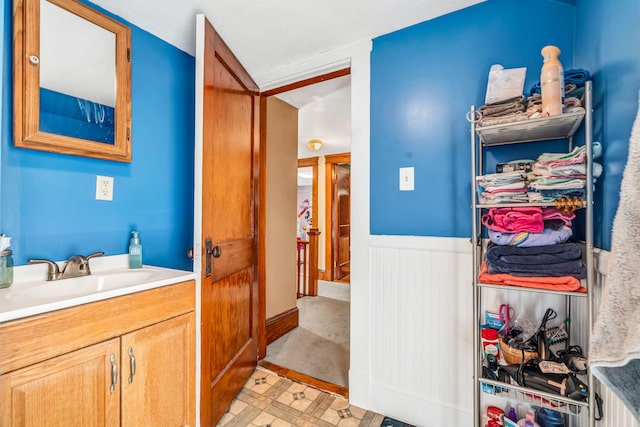 131 Pleasant St, Dexter, ME 04930 - bathroom featuring vanity and wainscoting