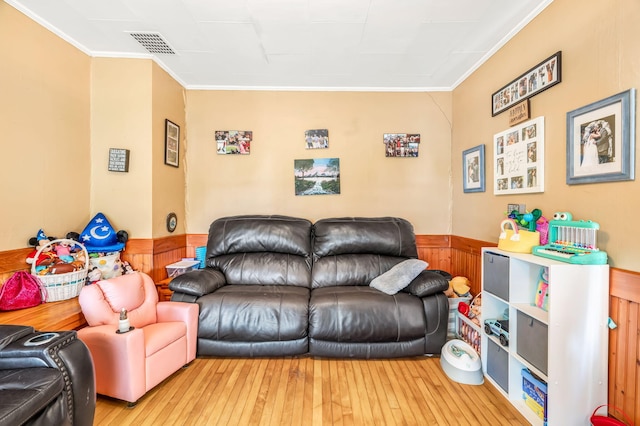 131 Pleasant St, Dexter, ME 04930 - living room with ornamental molding, hardwood / wood-style floors, and wainscoting