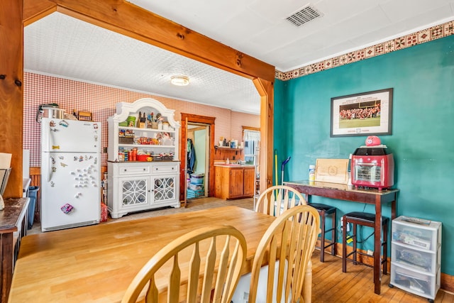 131 Pleasant St, Dexter, ME 04930 - dining room featuring hardwood / wood-style flooring and wallpapered walls
